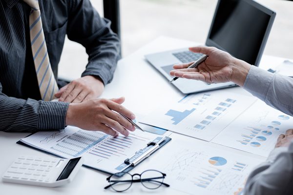 two_businessmen_looking_at_sales_data_sheets_in_th_2023_01_31_00 two_businessmen_looking_at_sales_data_sheets_in_th_2023_01_31_00